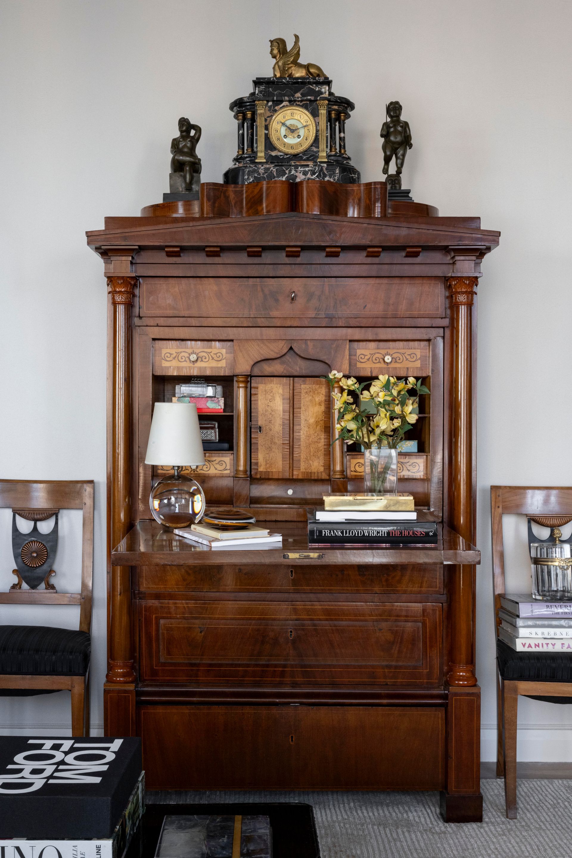A wooden desk with a clock on top of it