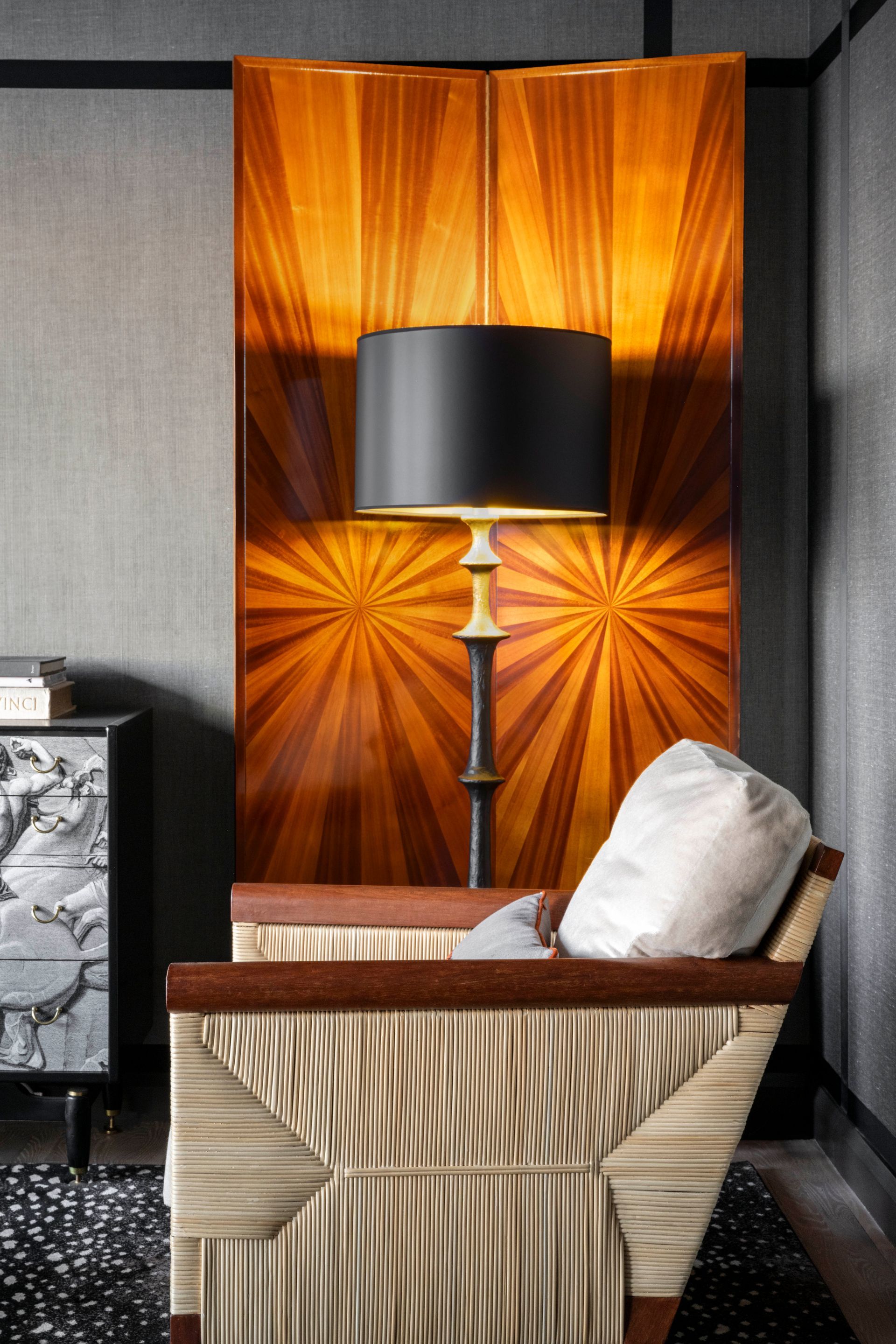 A living room with a chair and a lamp