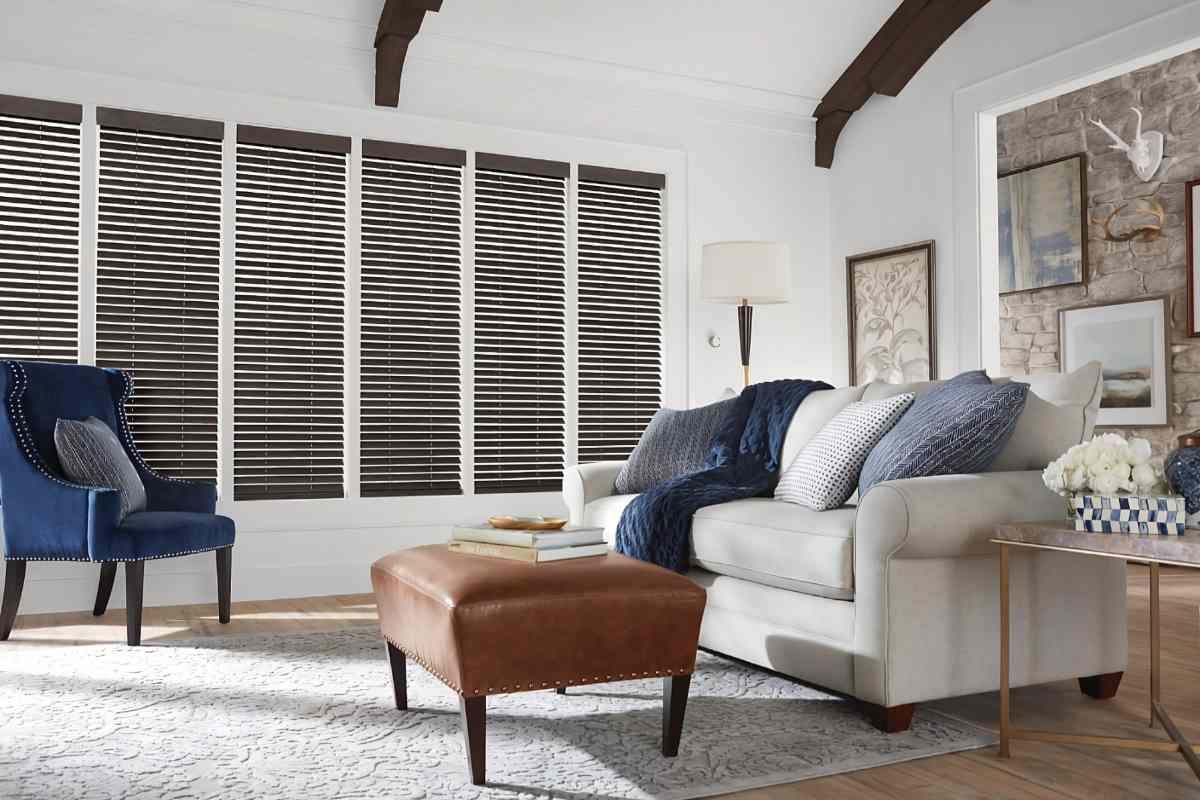 Hunter Douglas Parkland® Wood Blinds on tall windows in a traditional cozy living room near Tustin, CA