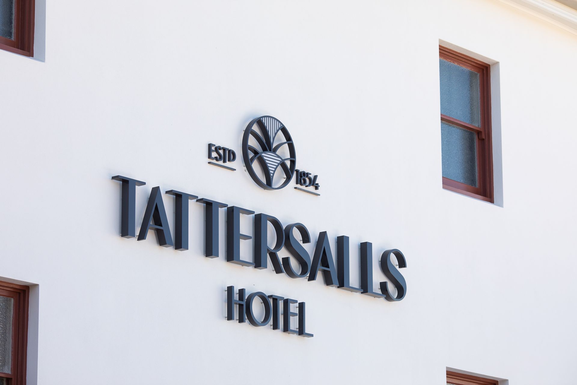 Close up of logo on front of Tattersalls Hotel in Armidale. Painted by love paint. 
