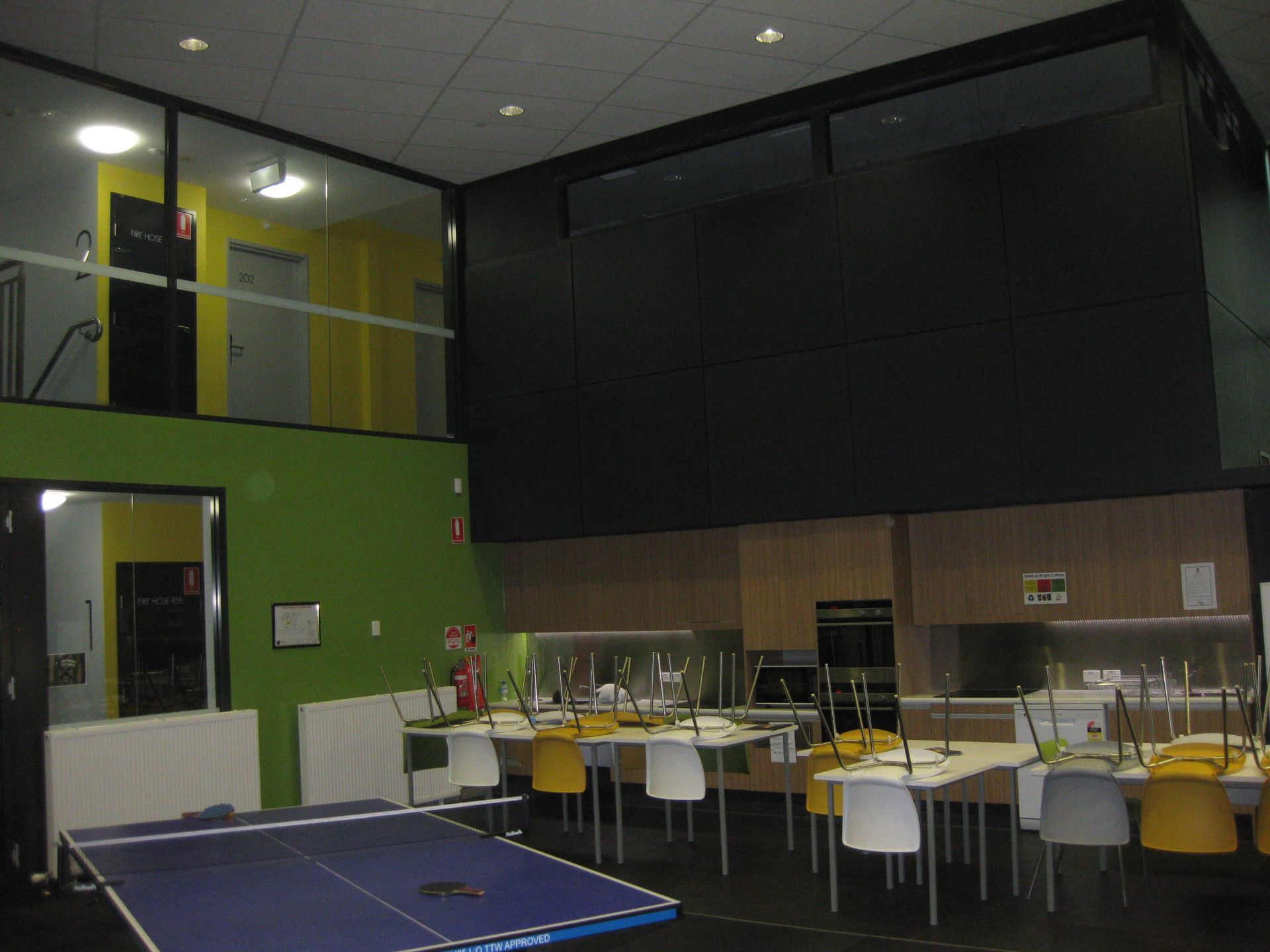 kitchen in common room with green feature wall