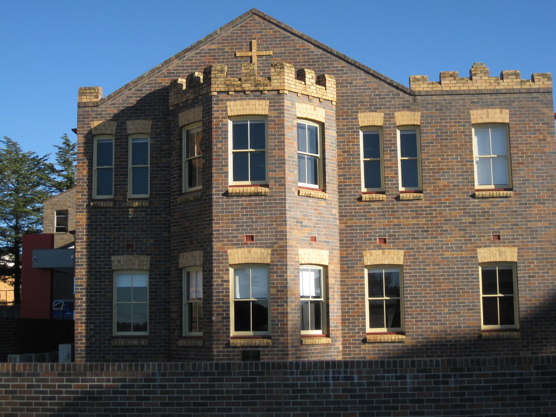 corner view of catholic cathedral precinct building with white roof
