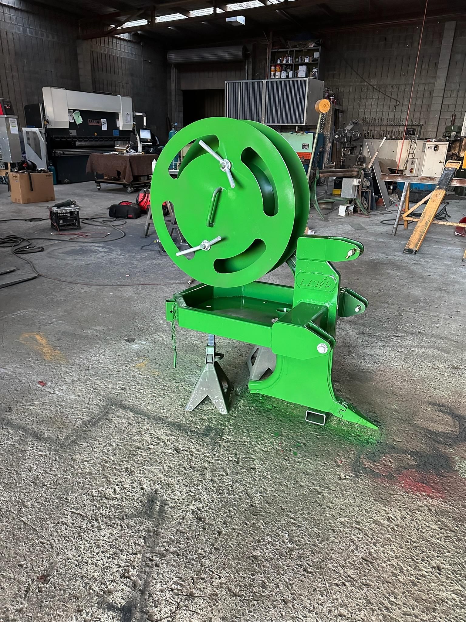 Bright green metal sculpture in a workshop