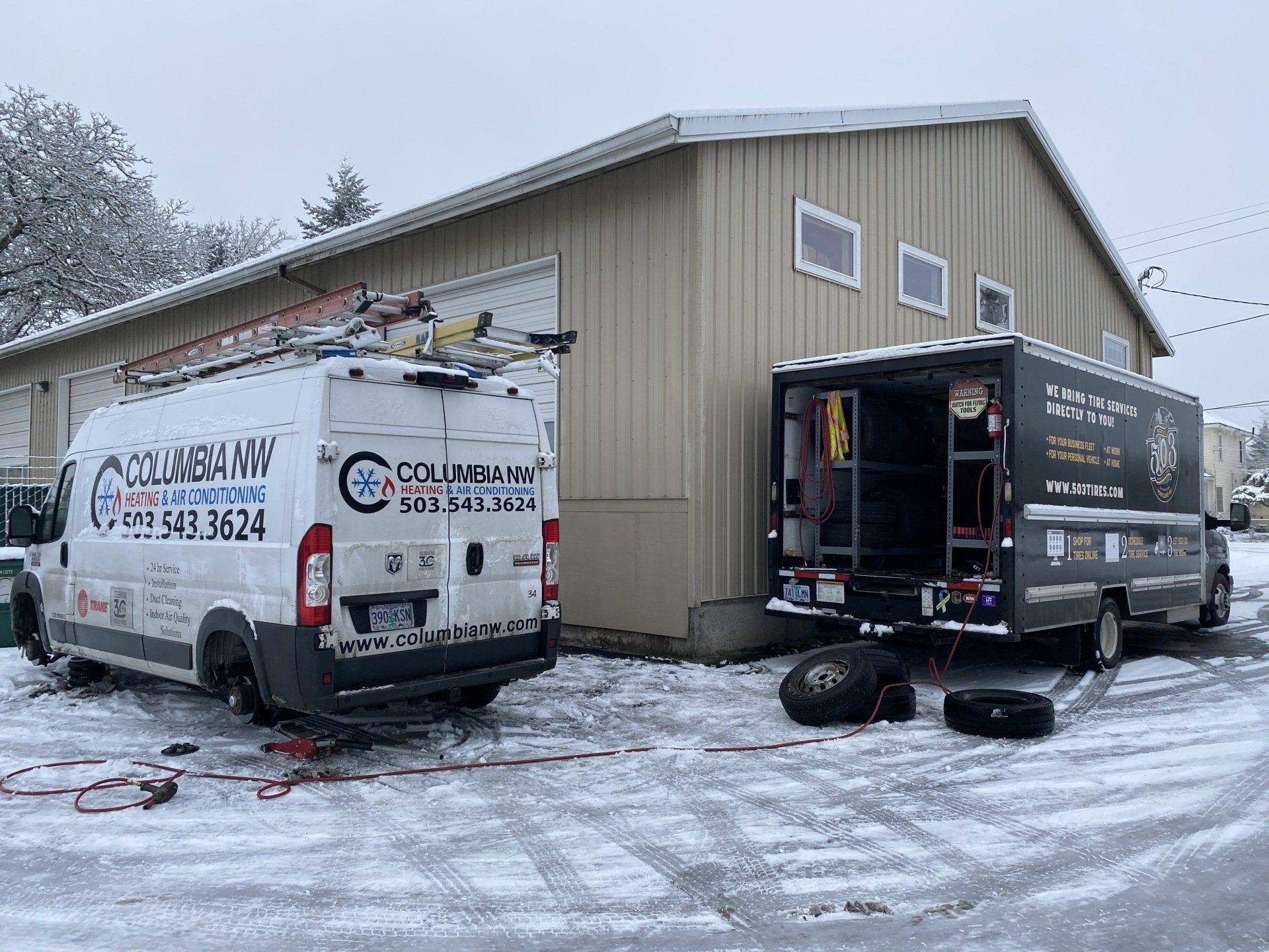 503 Tires mobile tire shop servicing a white van on the road.