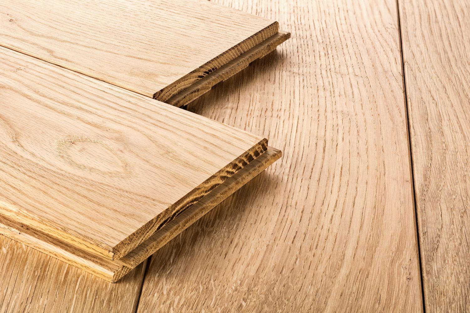 Two pieces of wood are stacked on top of each other on a wooden table.