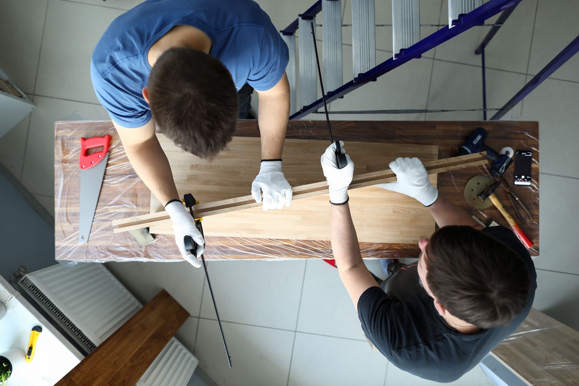 Two men are working on assembling a
wooden table.