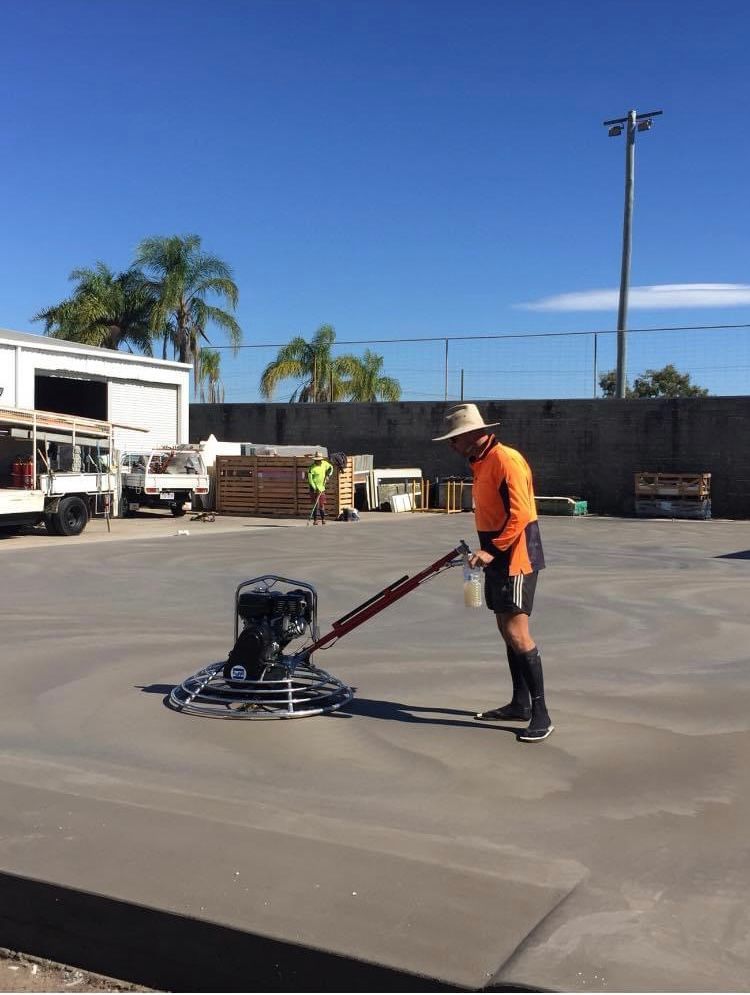 A Man Is Using A Machine For Concreting — Peter Bishop Concreting In Gympie, QLD