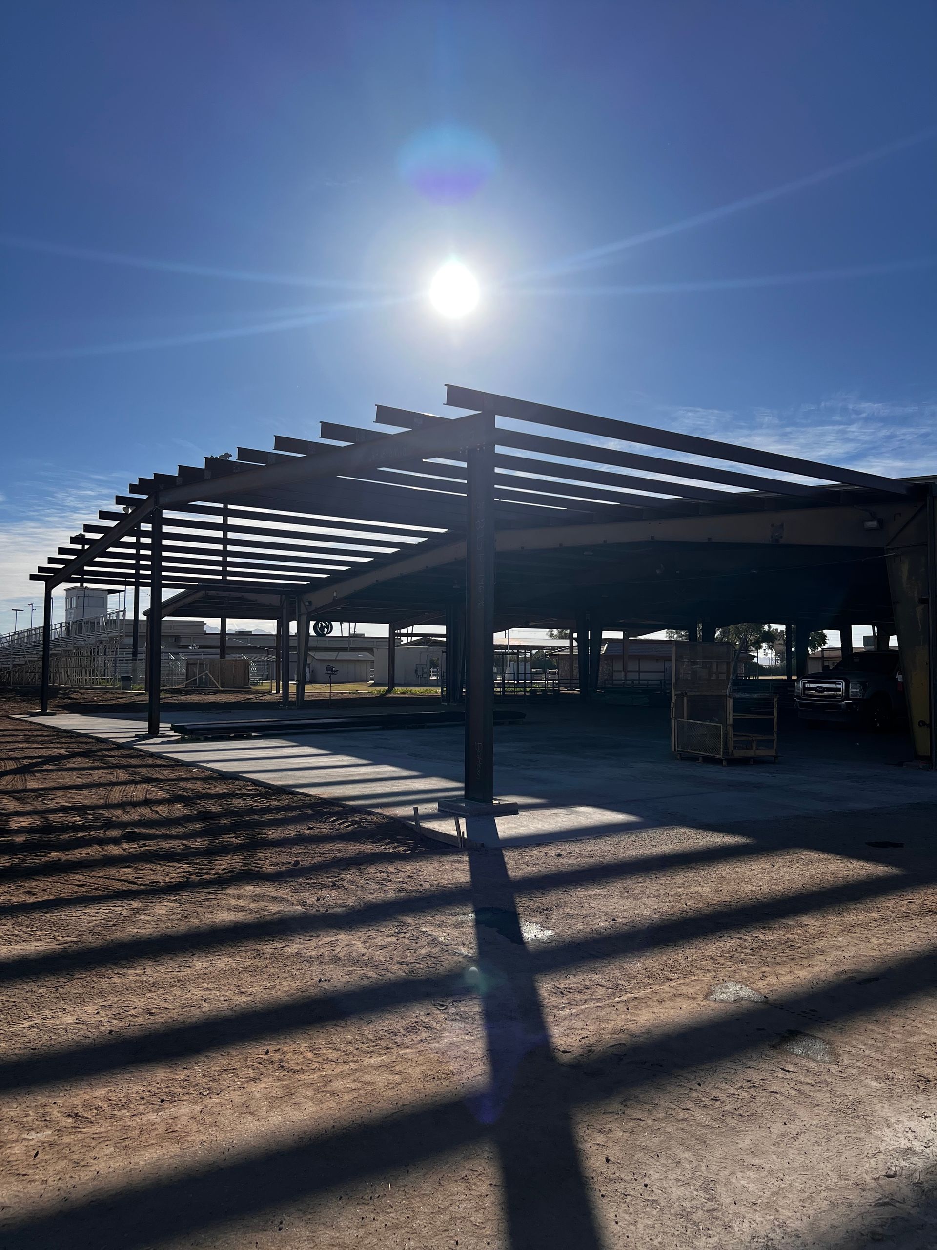A building under construction with the sun shining through the roof