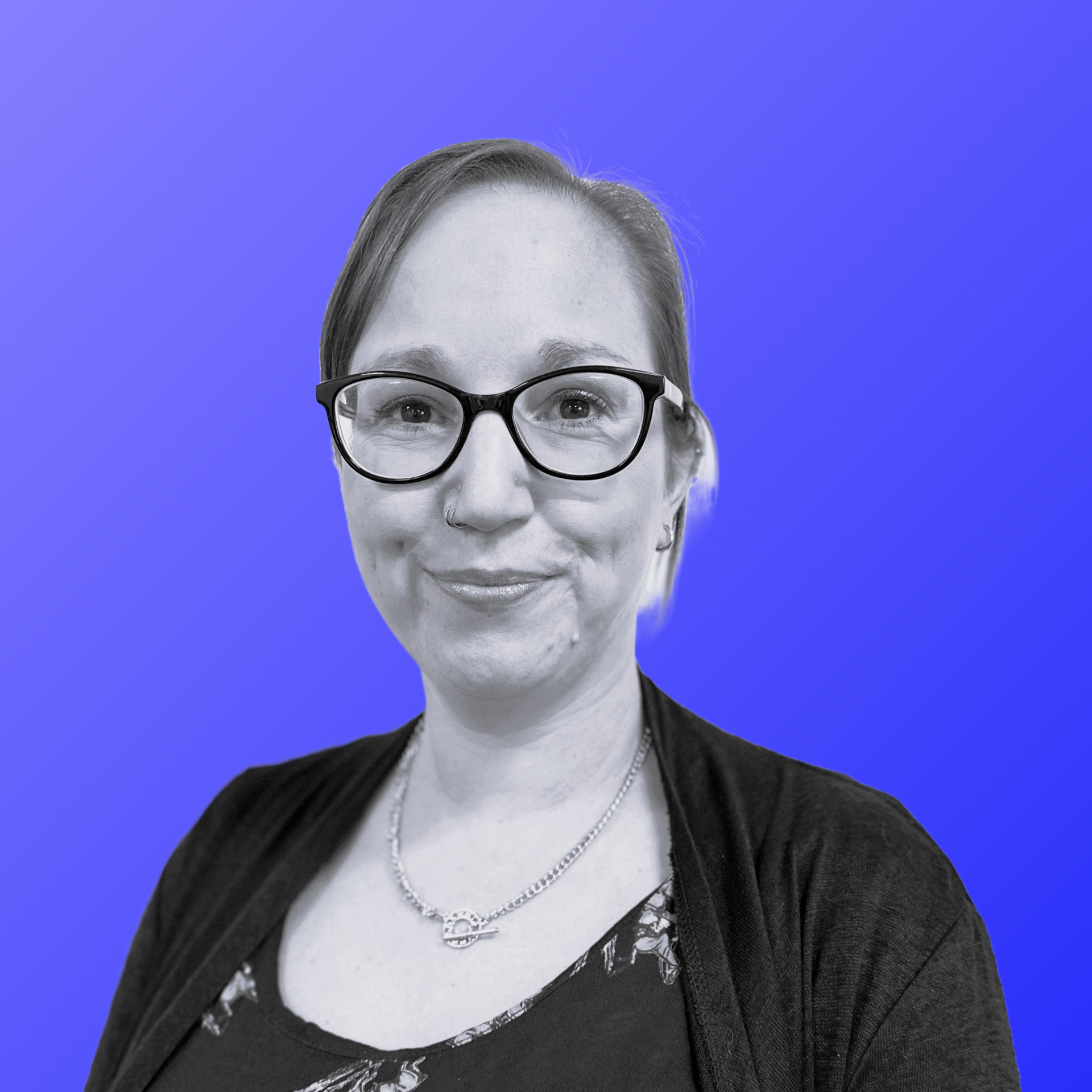 A woman is smiling in front of a blue background.