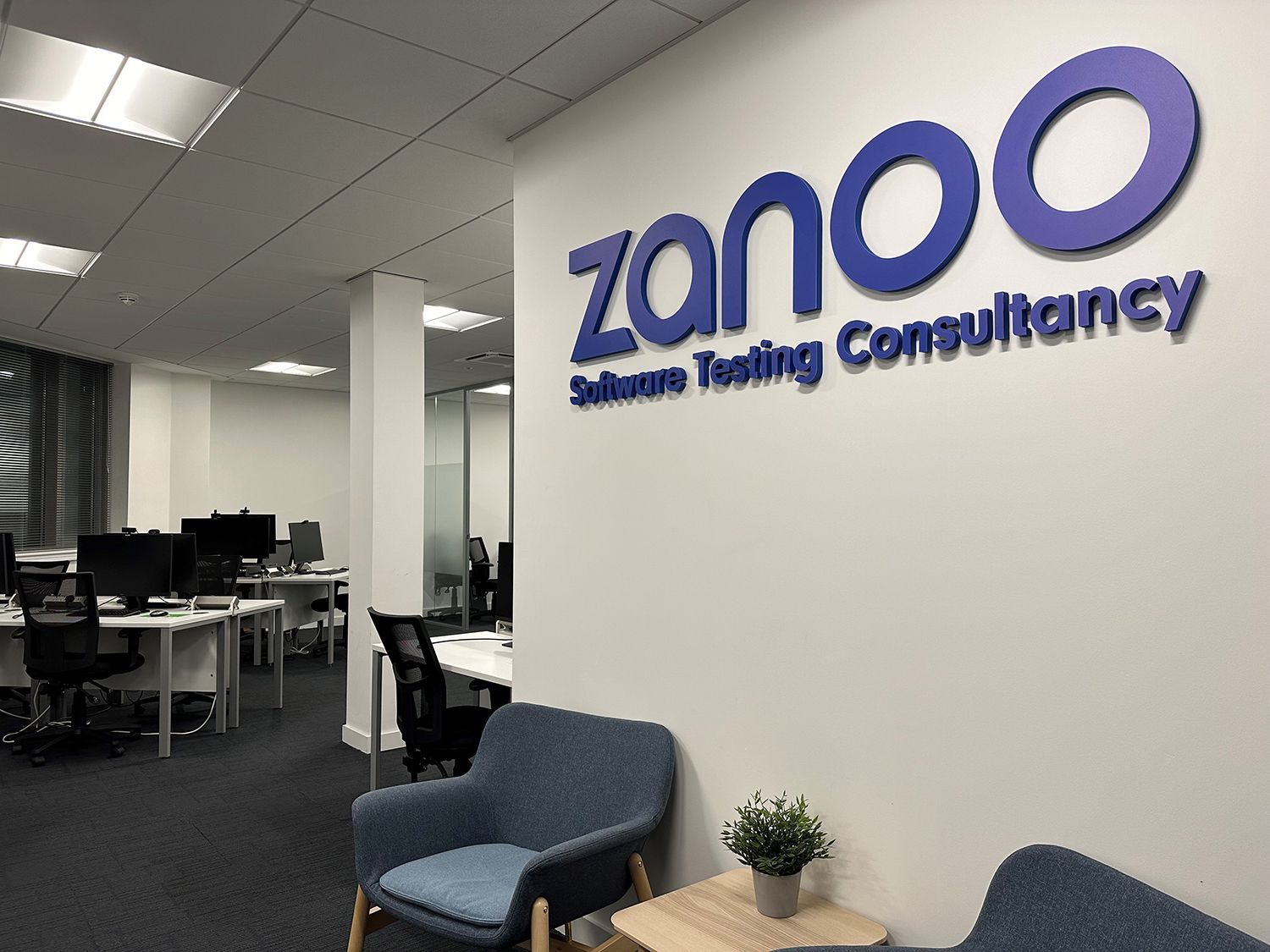 An office with a sign that says zanoo on it
