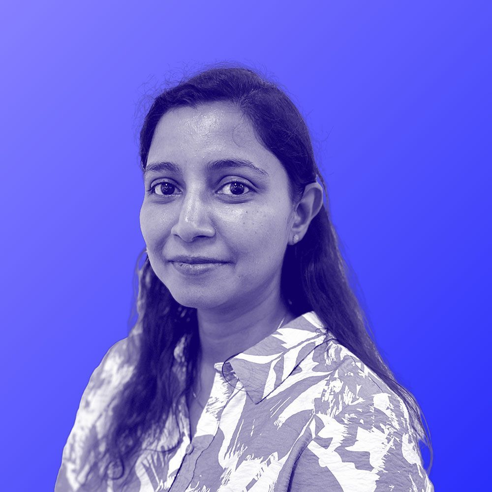 A black and white photo of a woman against a blue background.