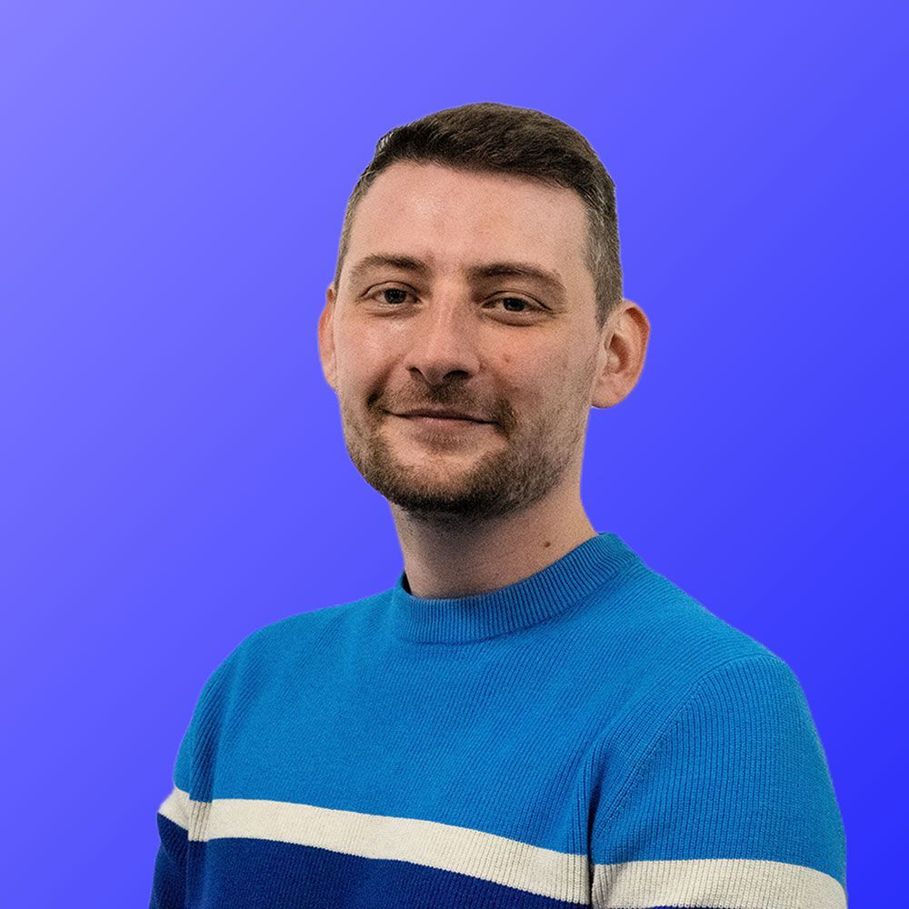 A man with a beard is wearing a blue and white striped sweater.