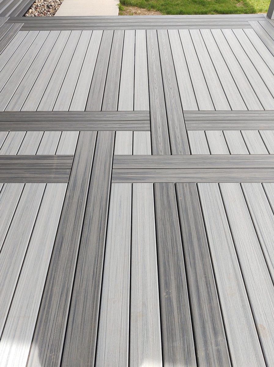 Gray composite deck boards arranged in a geometric herringbone pattern