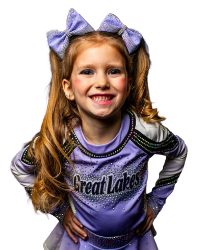 A little girl is wearing a purple cheerleading uniform with the word great lakes on it.