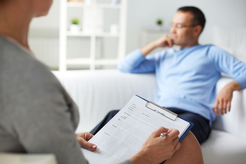 Therapist Taking Notes, Patient Sitting on Sofa — AT My Place Counselling and Psychotherapy in Neutral Bay, NSW