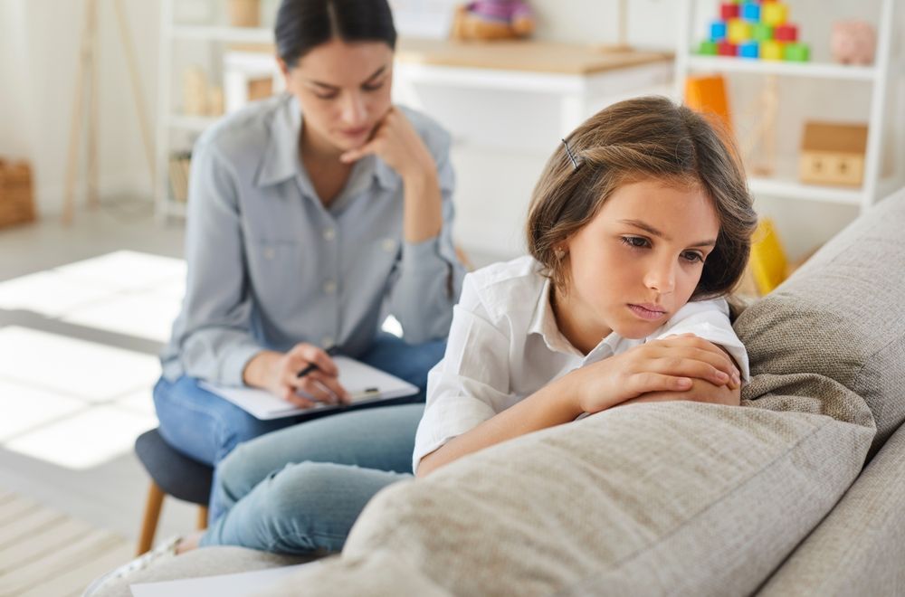 Girl on Couch Looking Sad, With Therapist — AT My Place Counselling and Psychotherapy in Neutral Bay, NSW