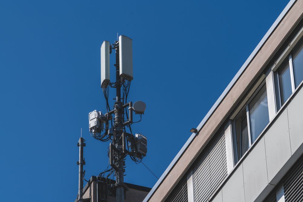Cell Tower Antennas Mounted on a Building Rooftop Against a Bright Blue Sky — Shane Kelly Communications in Lennox Head, NSW