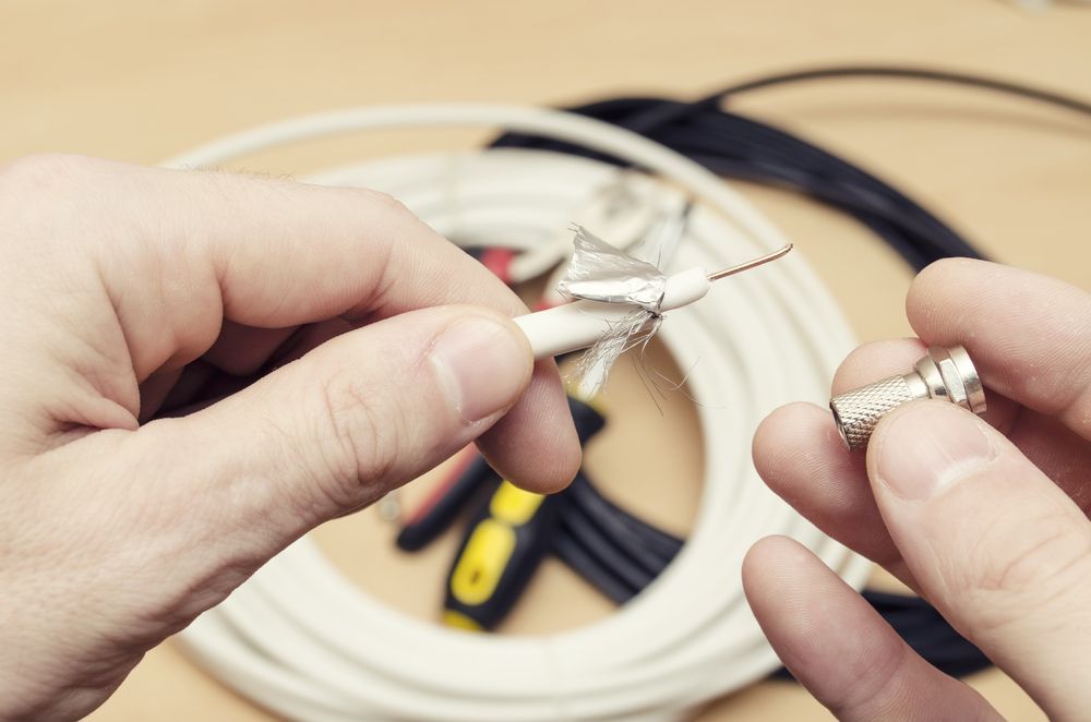 Hands Preparing a Coaxial Cable for a Connector — Shane Kelly Communications in Lennox Head, NSW