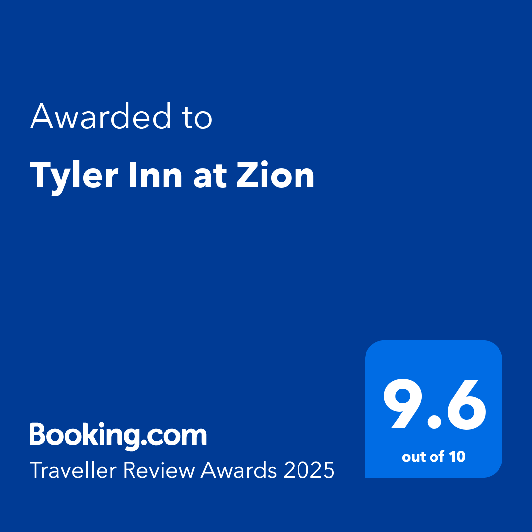 A blue sign that says ' awarded to tyler inn at zion ' on it