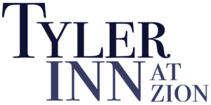 A blue logo for tyler inn at zion