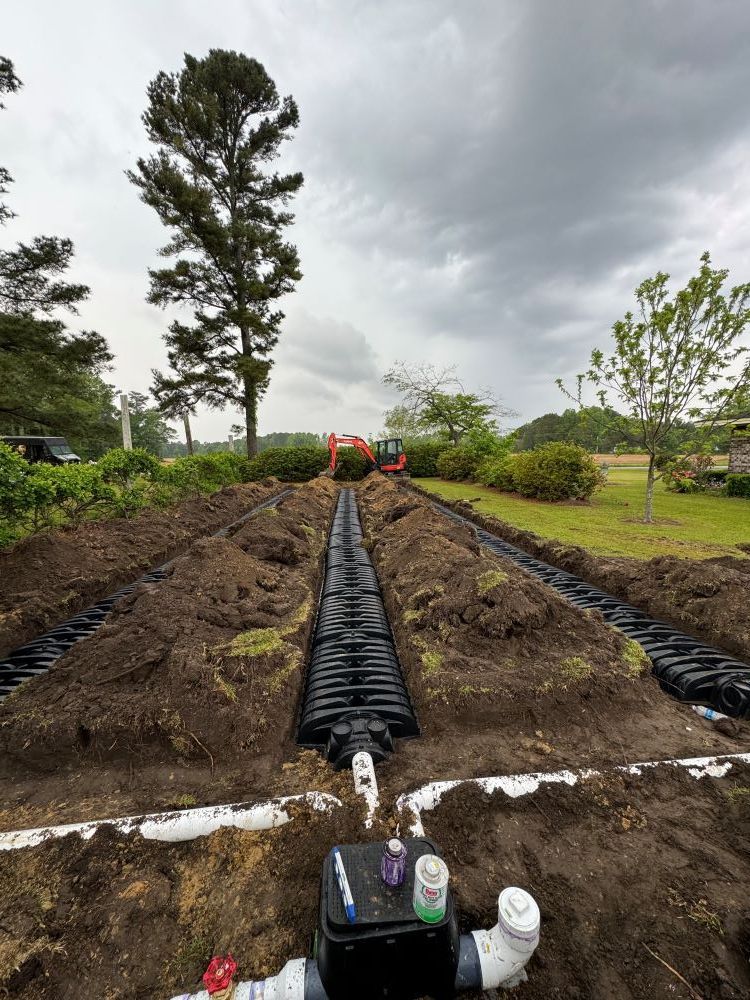 A septic system is being installed in a yard.