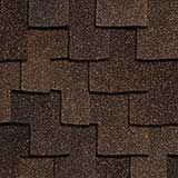 A close-up view of dark brown architectural asphalt shingles installed on a roof in an overlapping, staggered pattern.