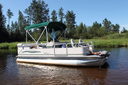 Pontoon Boat On A Lake — Lake Ozark, MO — DCL Boat Service Pontoon Boat On A Lake — Lake Ozark, MO — DCL Boat Service