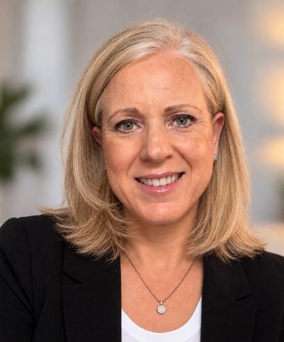 Agency owner Nancy Miller smiling and wearing a floral scarf