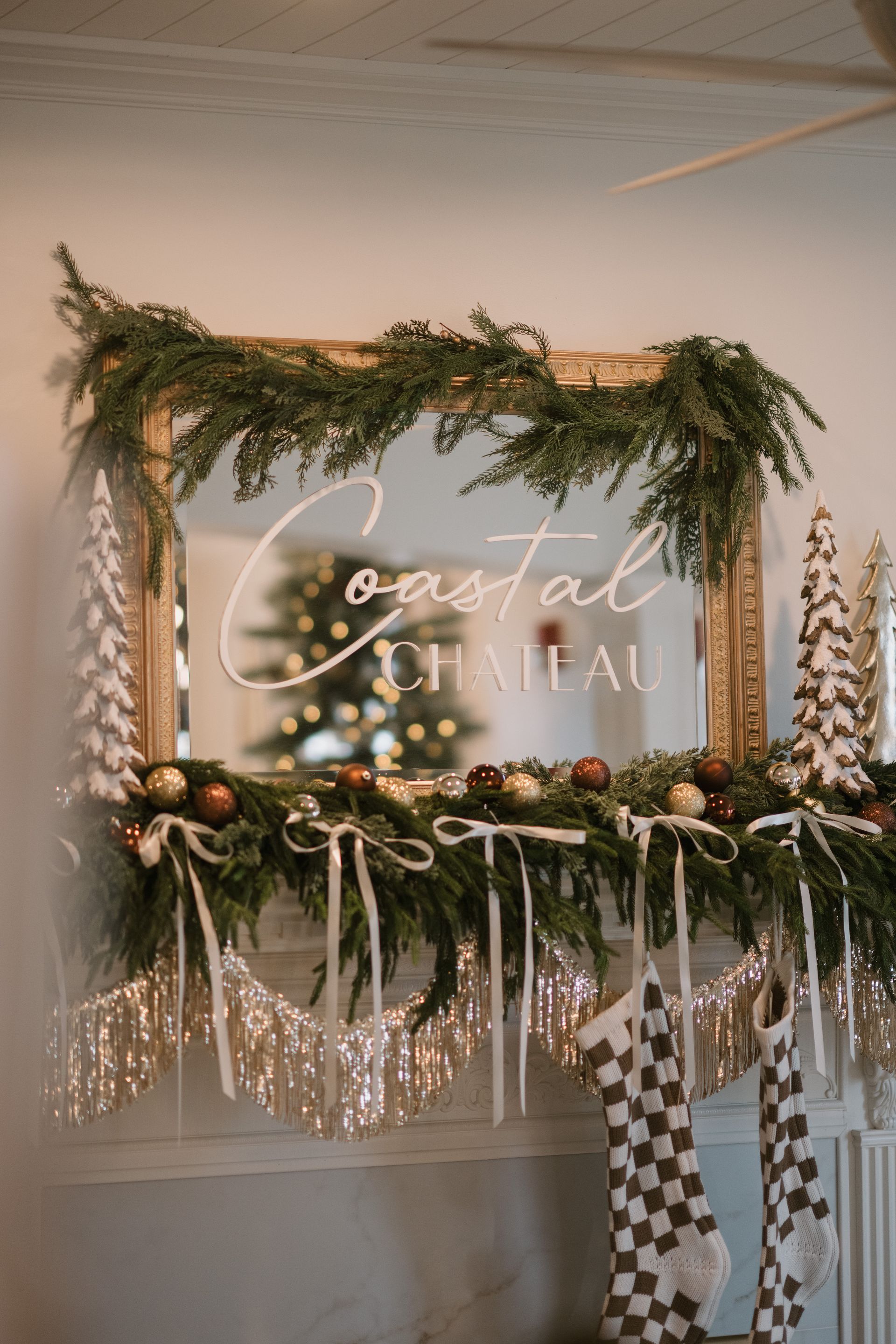 Christmas mantel decorated with greenery, ornaments, and