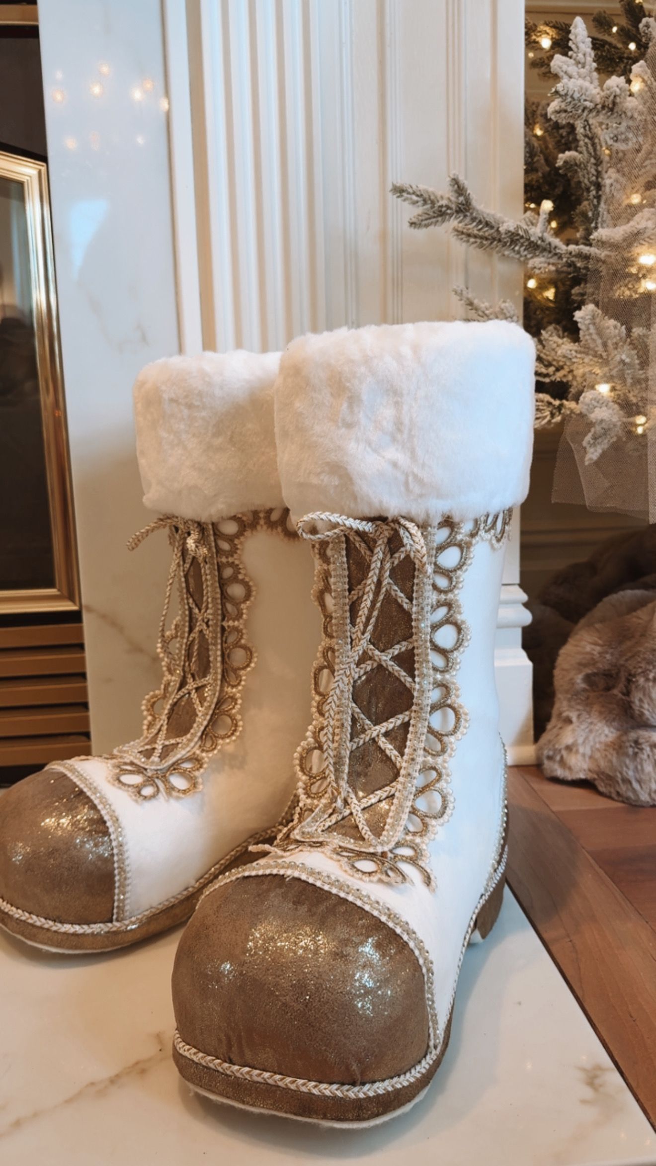 White and gold decorative boots with faux fur tops and sequined toes.