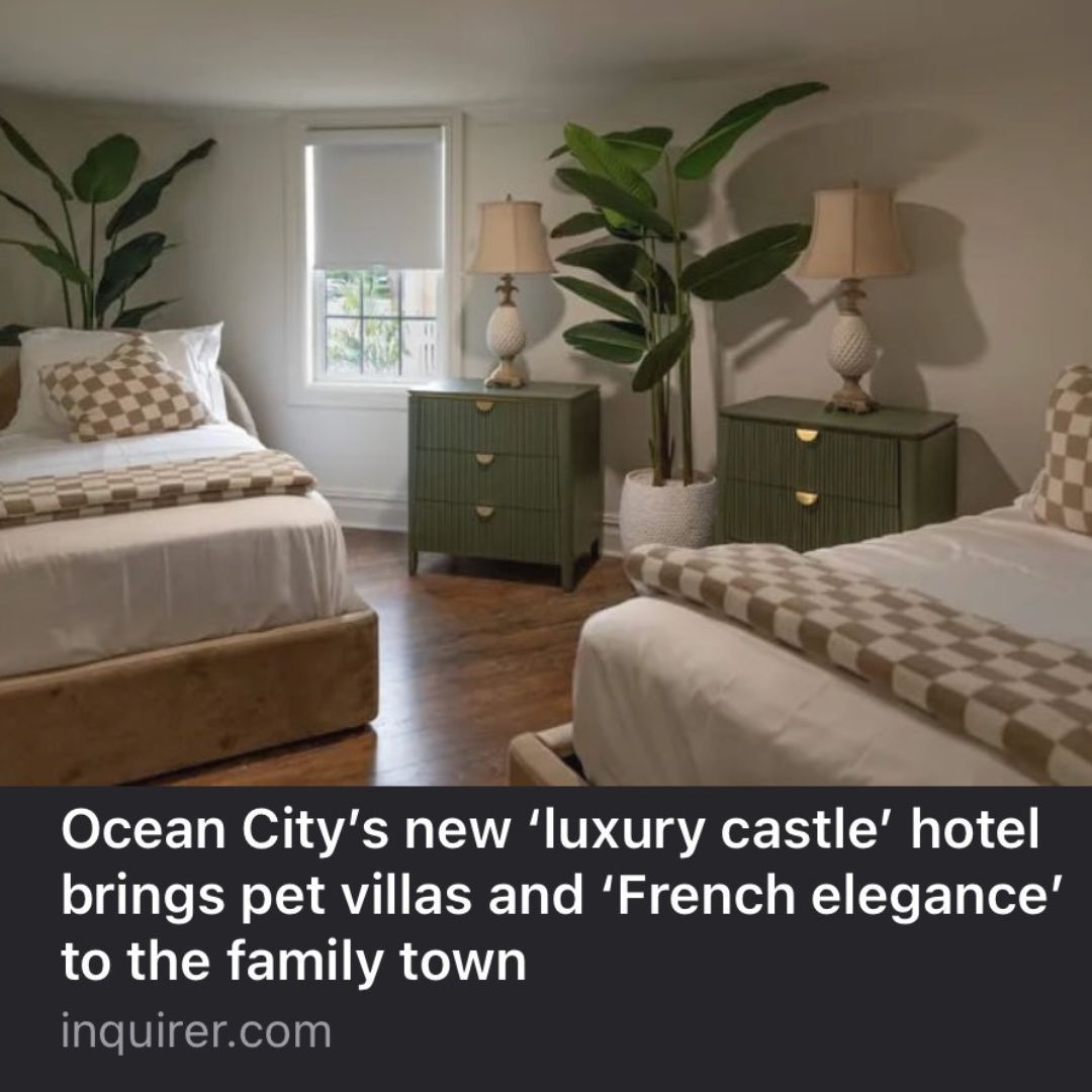 Bedroom in Ocean City hotel; two beds, green nightstands, plants, window, and a tan and white comforter.