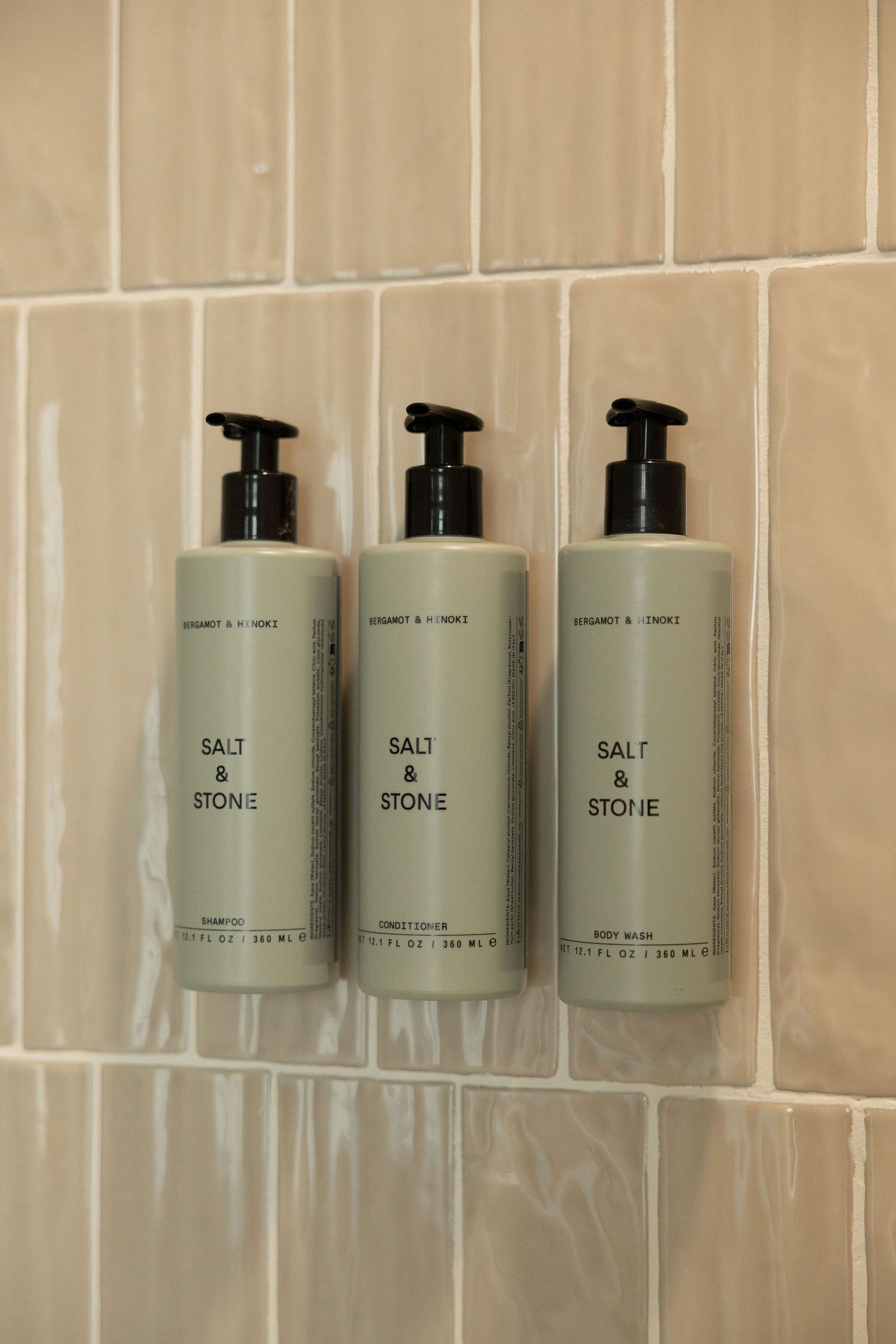Three gray pump bottles labeled