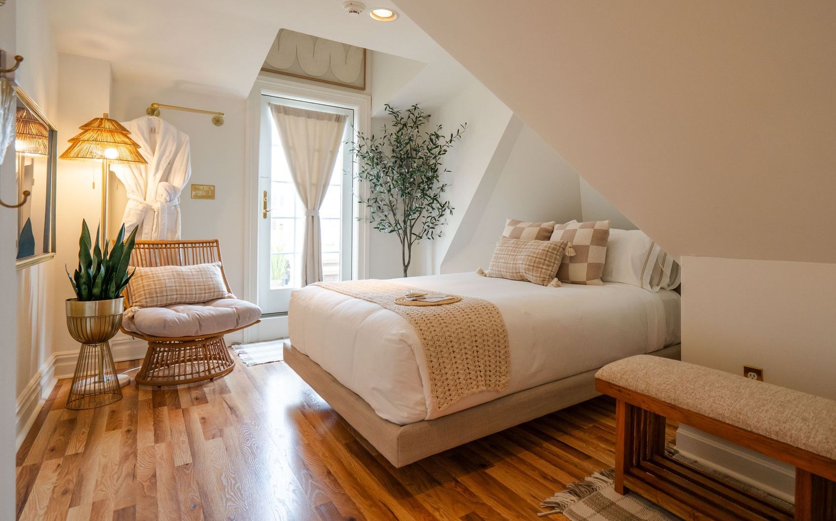 A bed with white sheets and a book on it.