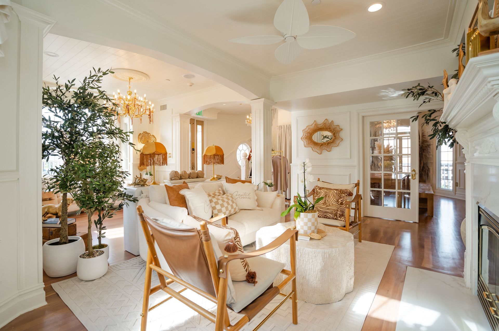 Elegant living room with white walls, fireplace, and ornate furnishings.