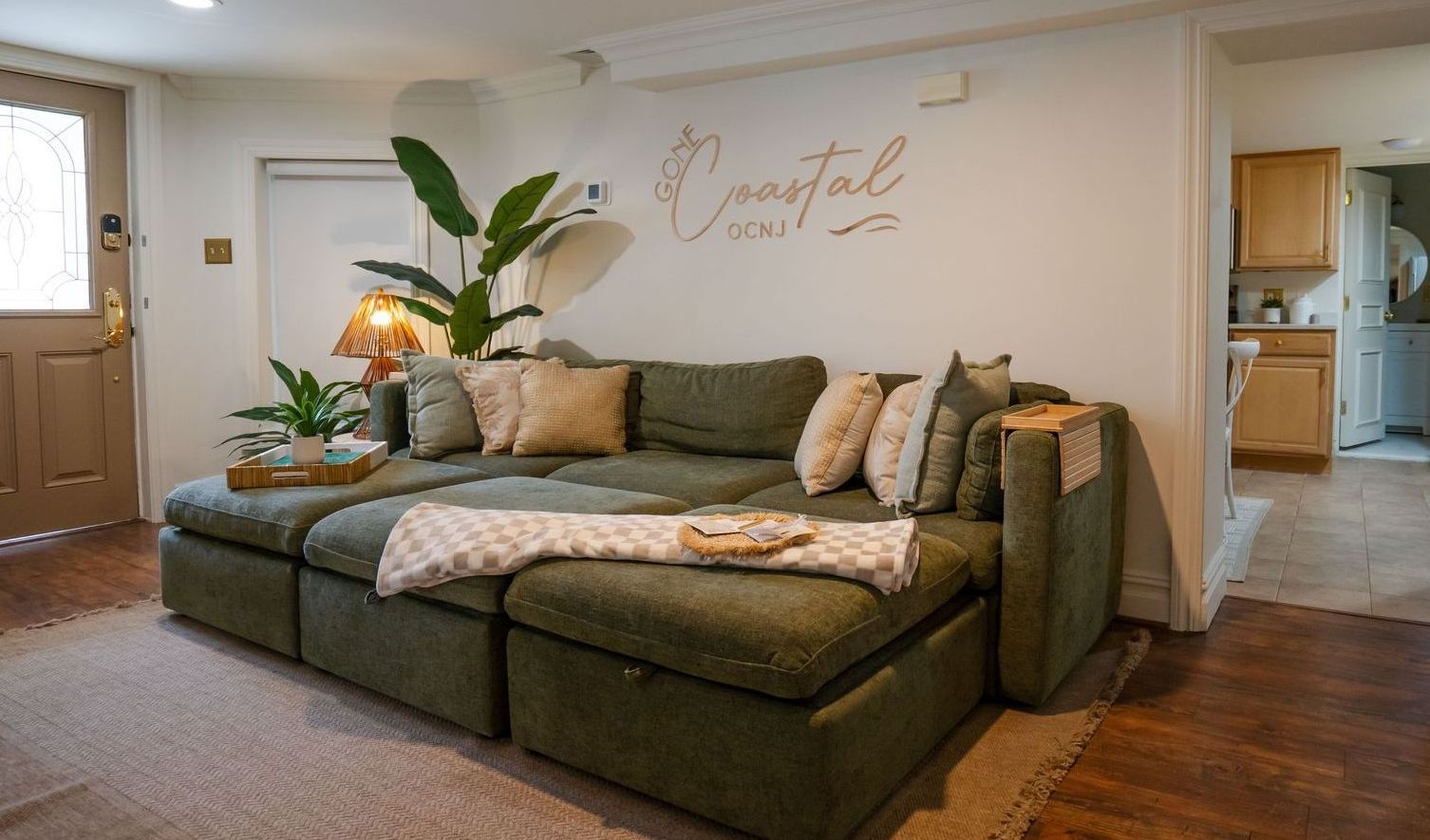 Green sectional sofa in a living room, with 