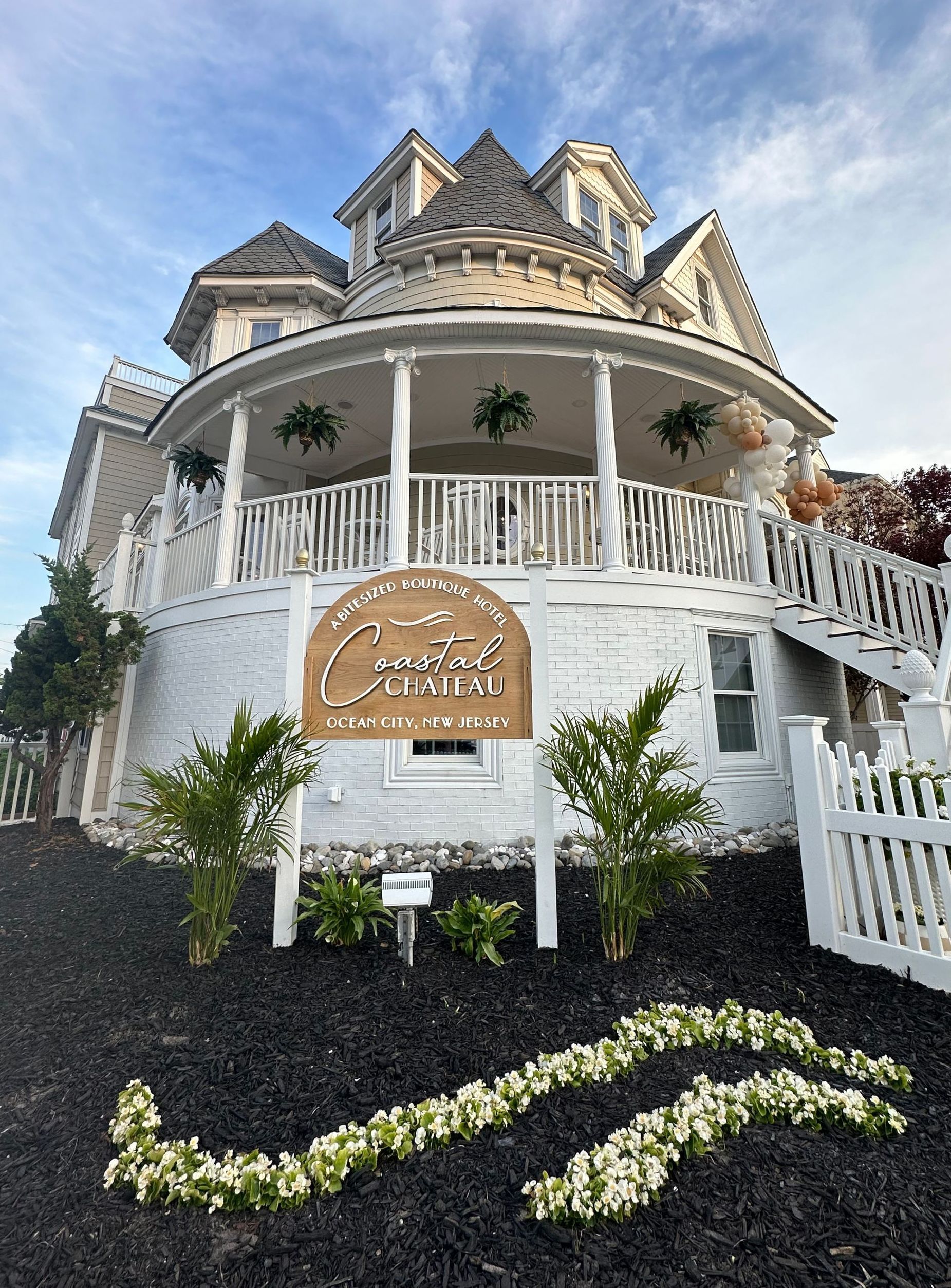 White Victorian-style house with sign: 