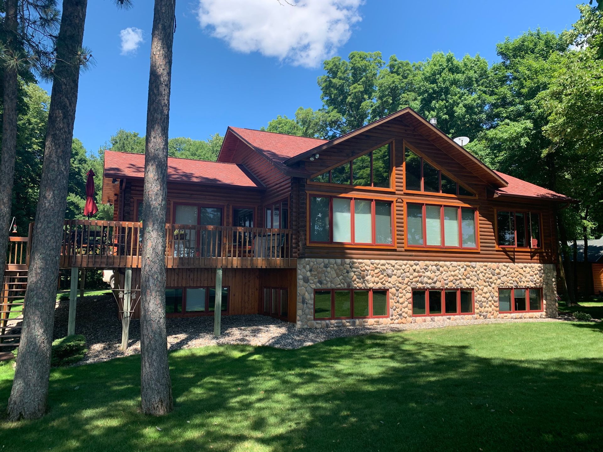 A Large House With a Red Roof – MN - Lifetime Staining and Log Restoration