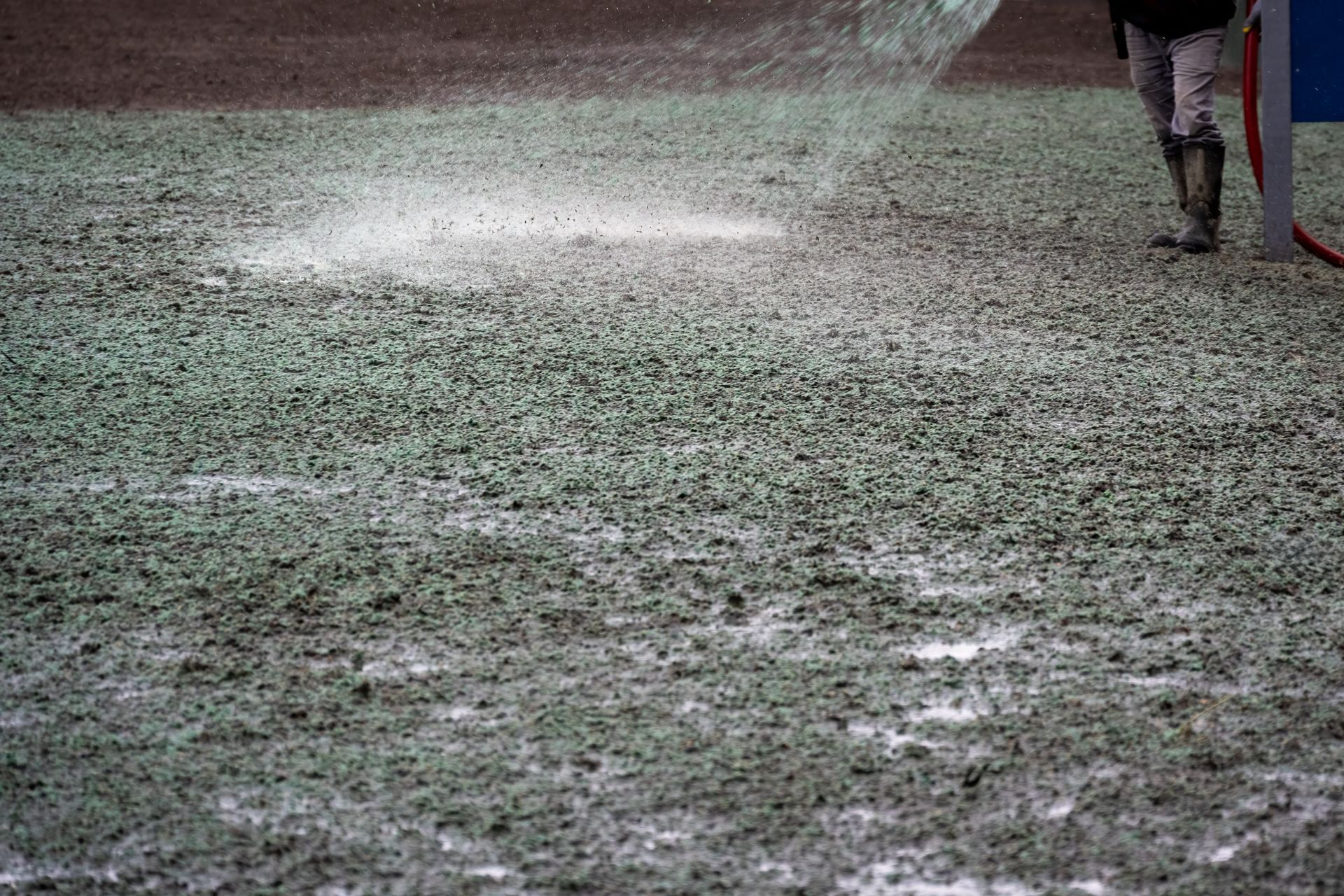 Snow-covered field with a bright patch of light and a person standing at the right edge