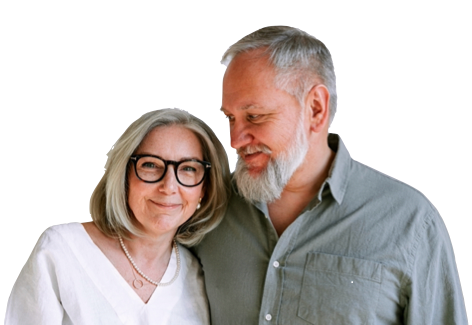 An older couple smiling, woman wearing glasses, man with a beard, standing side-by-side.