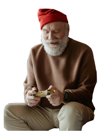 Elderly man with white beard and red hat plays video game, smiling.