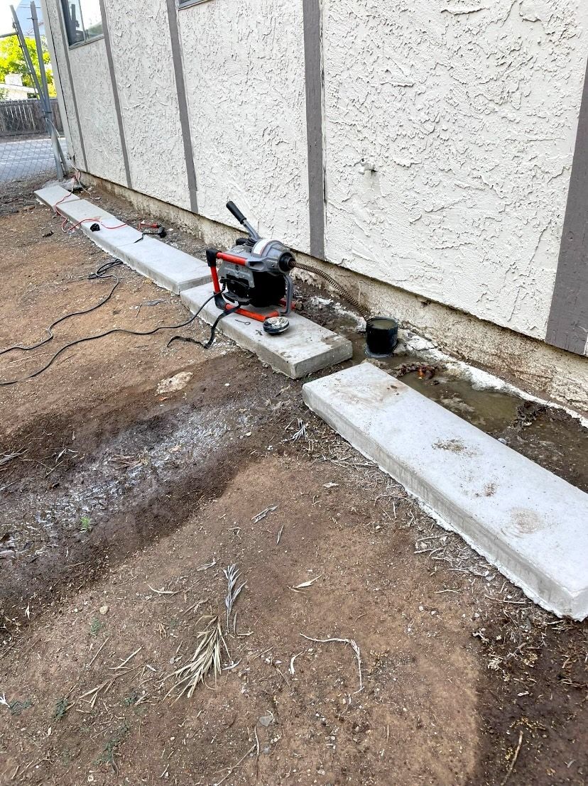 A concrete curb is being built in front of a building.