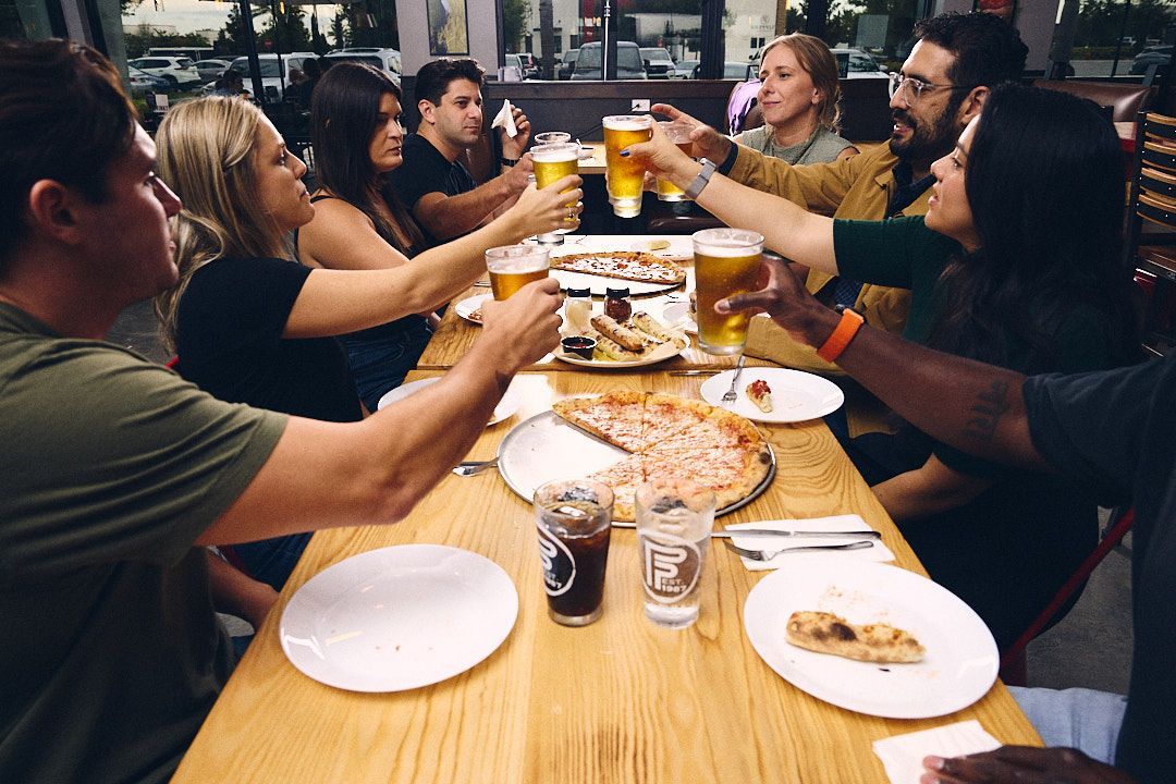 People enjoying Happy Hour at Flippers Pizza Co