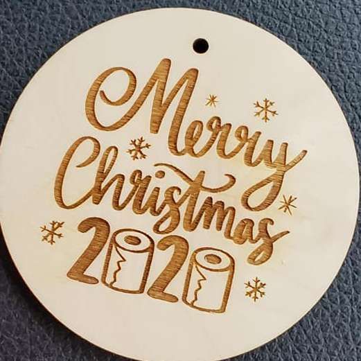 Round white ornament with gold “Merry Christmas 2020” script and a small hanging hole
