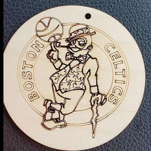 Boston Celtics logo on a round white plaque, featuring a leprechaun spinning a basketball.
