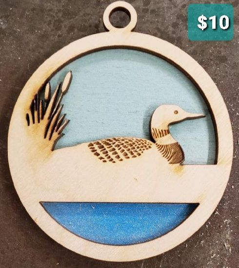 Round wooden ornament with a loon on blue water, marked $10