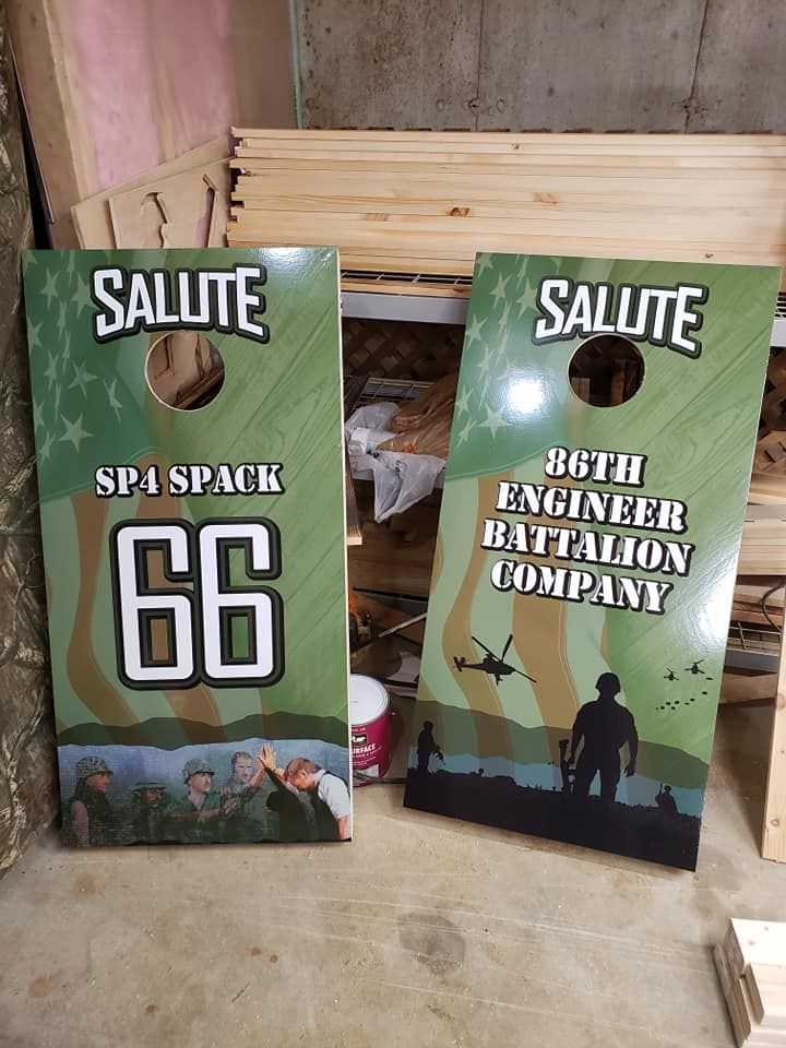 Two green Salute signs leaning against a wall, one for SP4 Spack 66 and one for 66th Engineer Battalion Company.