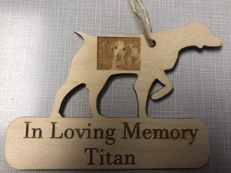 Wooden memorial dog ornament engraved “In Loving Memory Titan” on a light background