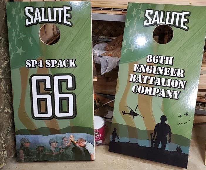 Two green Salute cornhole boards: one for SP4 Spack 66, one for 86th Engineer Battalion Company.