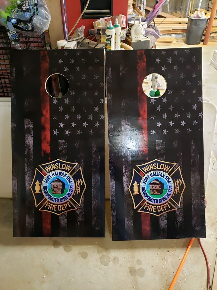 Two black star-patterned gift bags with badges, standing side by side on a table.