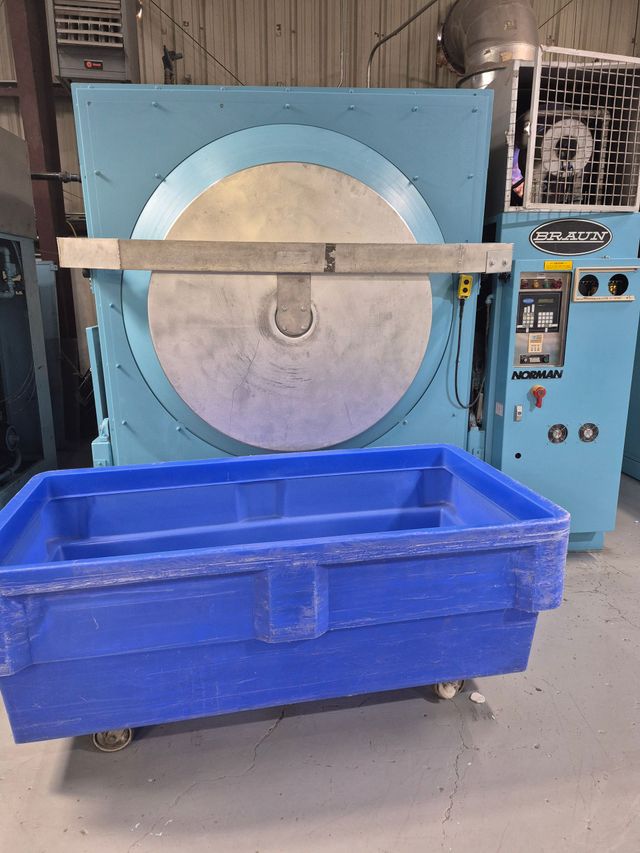 Blue industrial cleaning machine with a blue tub in front.
